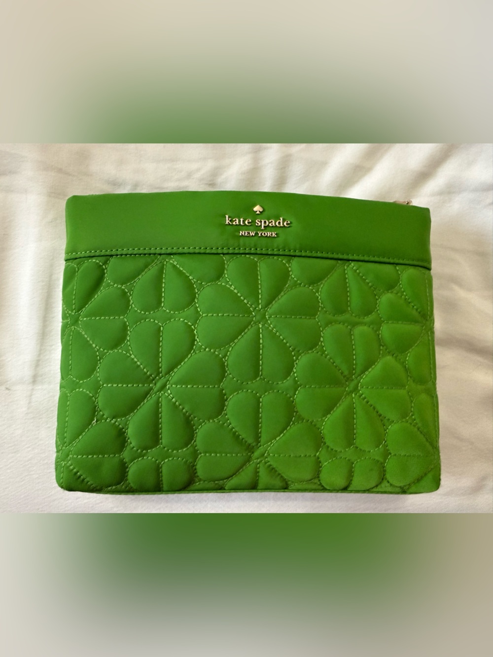 kate spade bright green quilted pouch with gold logo